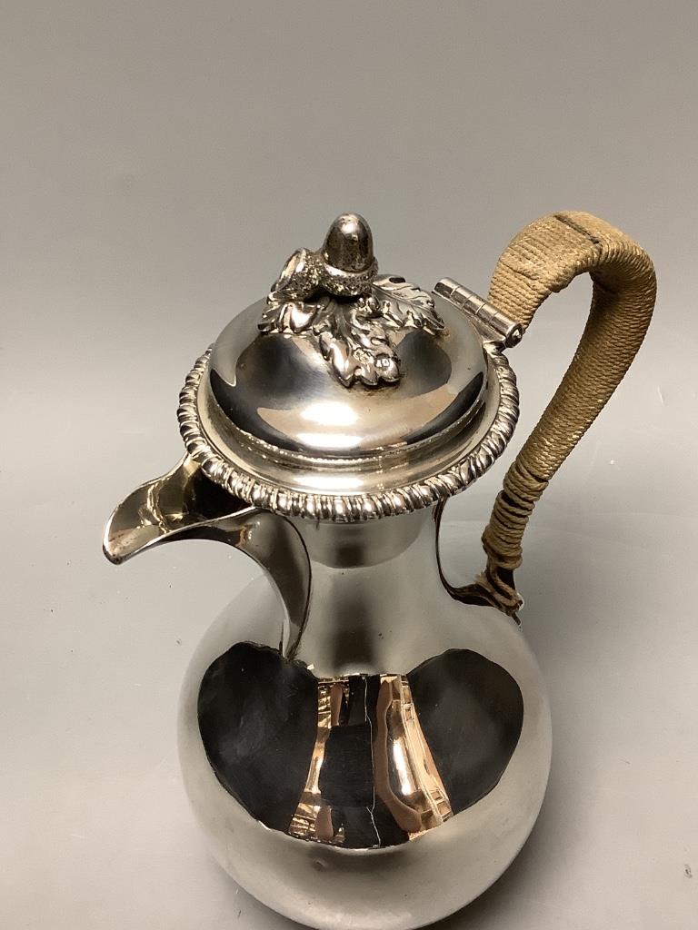 A Victorian silver baluster hot water jug, with acorn finial, by George Fox, London, 1876, height 25cm